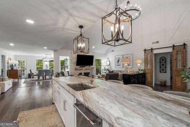 6477 Old Shadburn Ferry Rd, Buford, GA 30518 - kitchen featuring open floor plan, a sink, dishwasher, a chandelier, and white cabinets
