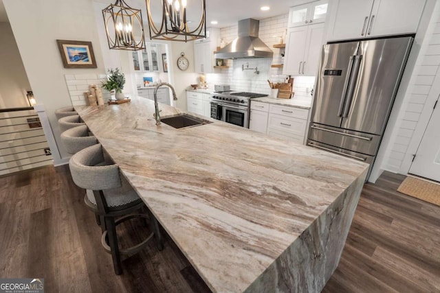 6477 Old Shadburn Ferry Rd, Buford, GA 30518 - kitchen featuring wall chimney range hood, appliances with stainless steel finishes, a sink, dark wood-style flooring, and recessed lighting