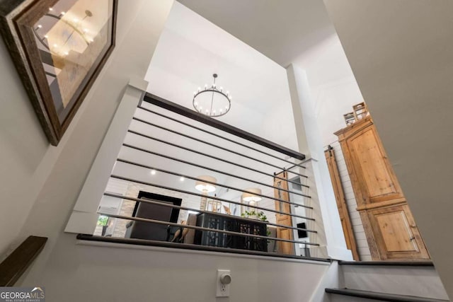 6477 Old Shadburn Ferry Rd, Buford, GA 30518 - stairway featuring a high ceiling and a chandelier