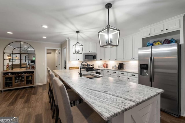 6477 Old Shadburn Ferry Rd, Buford, GA 30518 - kitchen with stainless steel appliances, a chandelier, a sink, crown molding, and white cabinetry