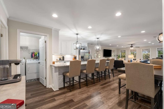 6477 Old Shadburn Ferry Rd, Buford, GA 30518 - dining space with separate washer and dryer, crown molding, recessed lighting, dark wood-style floors, and ceiling fan