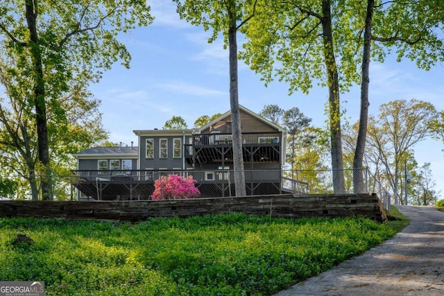 6477 Old Shadburn Ferry Rd, Buford, GA 30518 - back of house featuring a wooden deck and fence