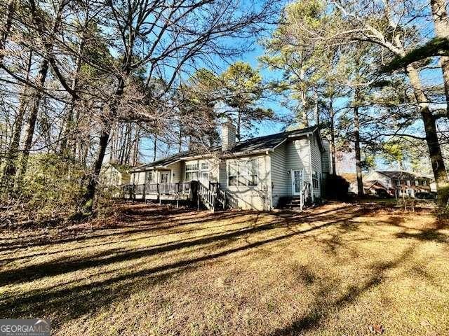 exterior space featuring entry steps, a chimney, and a wooden deck