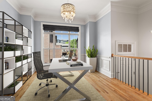 empty room featuring an inviting chandelier, ornamental molding, and wood finished floors