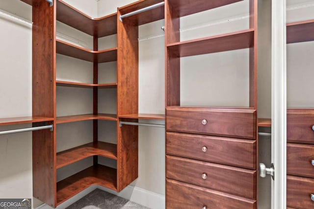 clothes washing area featuring laundry area, crown molding, independent washer and dryer, light carpet, and baseboards