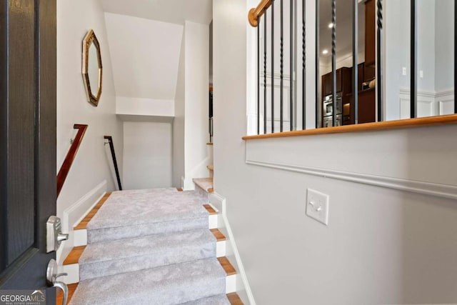staircase with wood finished floors