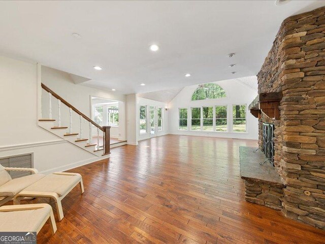5761 Kentucky Downs Dr, Macon, GA 31210 - unfurnished living room with wood-type flooring, a fireplace, stairway, lofted ceiling, and recessed lighting
