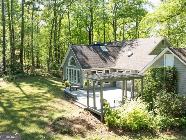 5761 Kentucky Downs Dr, Macon, GA 31210 - rear view of house with a standing seam roof, a yard, a metal roof, and a shingled roof
