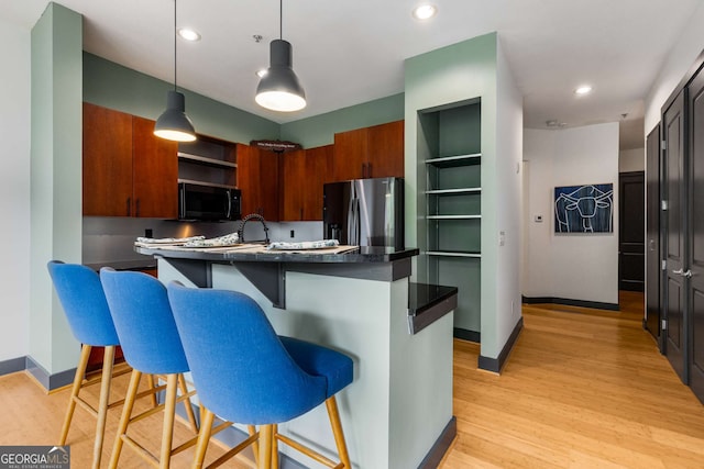747 Ralph Mcgill Blvd NE Unit 223, Atlanta, GA 30312 - kitchen featuring stainless steel fridge with ice dispenser, black microwave, dark countertops, open shelves, and baseboards
