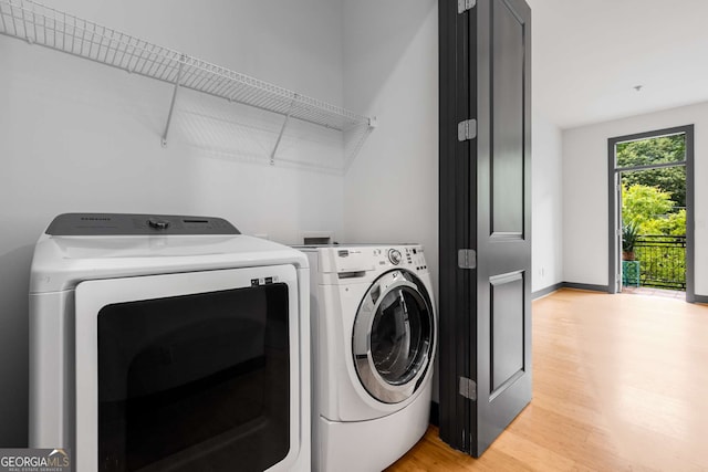 747 Ralph Mcgill Blvd NE Unit 223, Atlanta, GA 30312 - laundry room with separate washer and dryer, light wood-style flooring, and baseboards