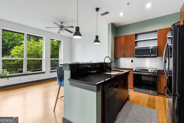 747 Ralph Mcgill Blvd NE Unit 223, Atlanta, GA 30312 - kitchen with appliances with stainless steel finishes, a sink, dark countertops, a ceiling fan, and light wood-type flooring