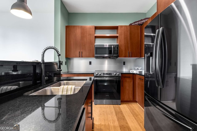 747 Ralph Mcgill Blvd NE Unit 223, Atlanta, GA 30312 - kitchen featuring appliances with stainless steel finishes, a sink, brown cabinetry, open shelves, and dark stone counters