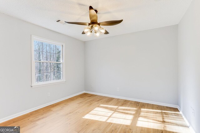 5465 N Fork Dr SW, Lilburn, GA 30047 - spare room with visible vents, ceiling fan, light wood-type flooring, and baseboards