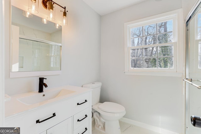 5465 N Fork Dr SW, Lilburn, GA 30047 - full bathroom featuring vanity, baseboards, toilet, a shower with shower door, and marble finish floor