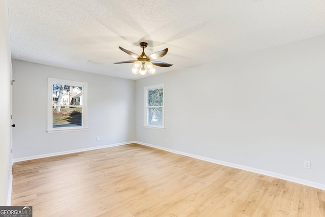 5465 N Fork Dr SW, Lilburn, GA 30047 - unfurnished room with light wood-style flooring, baseboards, and ceiling fan