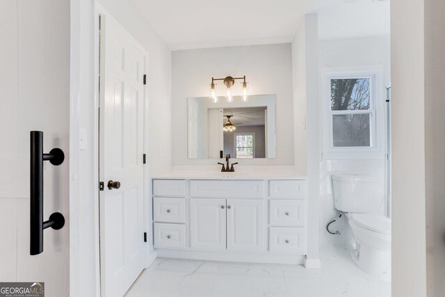 5465 N Fork Dr SW, Lilburn, GA 30047 - bathroom featuring ceiling fan, toilet, marble finish floor, and vanity