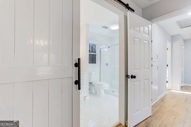 5465 N Fork Dr SW, Lilburn, GA 30047 - interior space featuring visible vents, toilet, wood finished floors, a stall shower, and baseboards