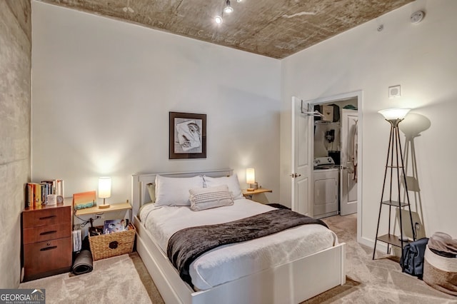 bedroom with carpet flooring and washer / dryer