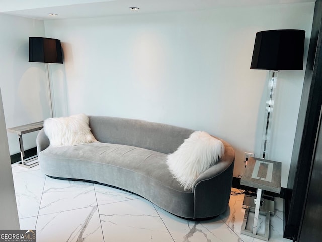 living area featuring recessed lighting and marble finish floor