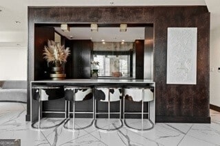 bar featuring marble finish floor