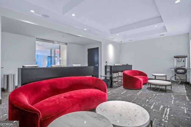 living room featuring recessed lighting and a tray ceiling