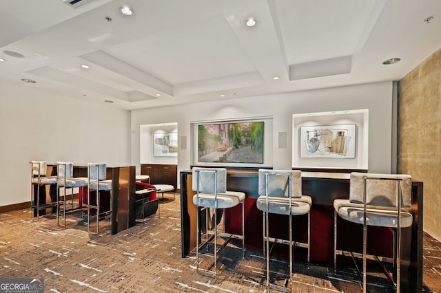 bar featuring a tray ceiling, baseboards, and recessed lighting