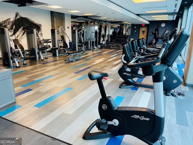 gym with a paneled ceiling