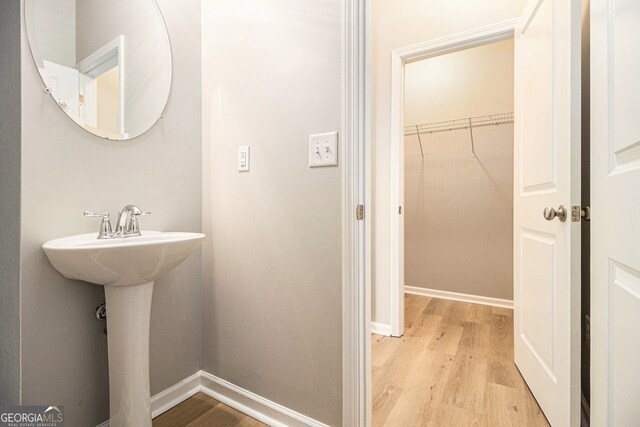 hall featuring an upstairs landing, visible vents, light colored carpet, and baseboards