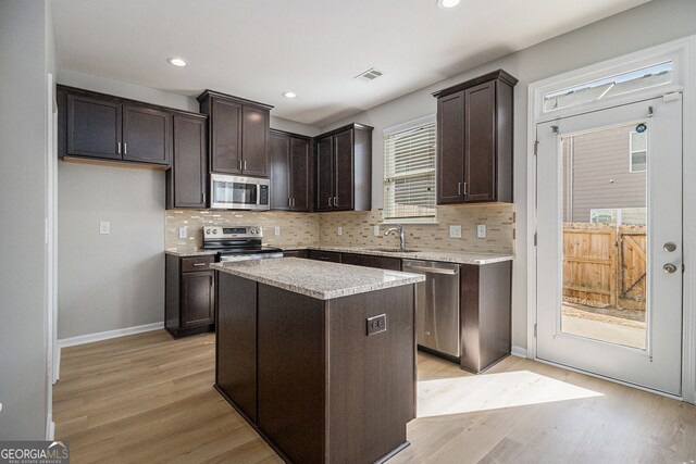 unfurnished dining area featuring light wood-style flooring, a notable chandelier, visible vents, and a wealth of natural light