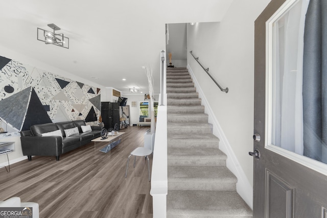 stairway featuring wood finished floors, recessed lighting, and baseboards