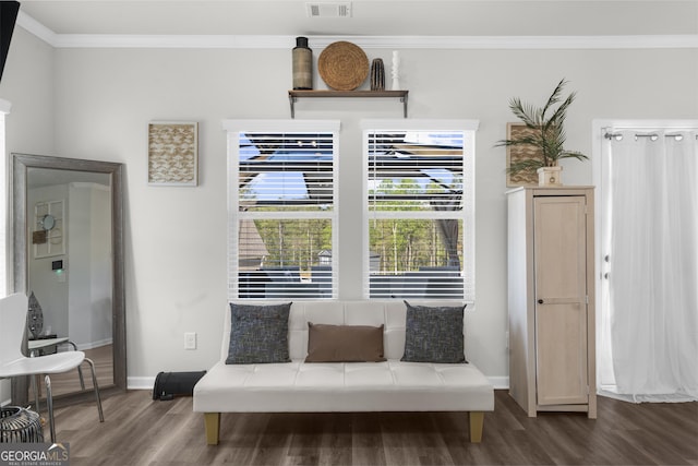 sitting room with ornamental molding, visible vents, wood finished floors, and baseboards