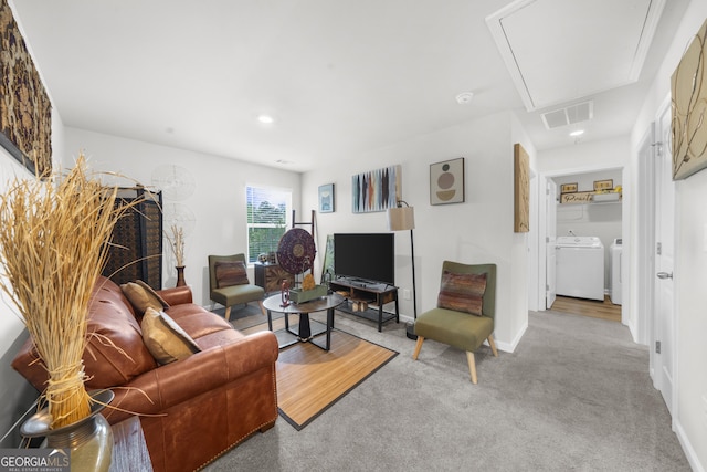 carpeted living area with recessed lighting, washer and dryer, attic access, baseboards, and visible vents