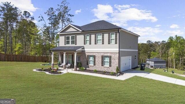 view of front of property featuring brick siding, fence, a garage, a front yard, and concrete driveway