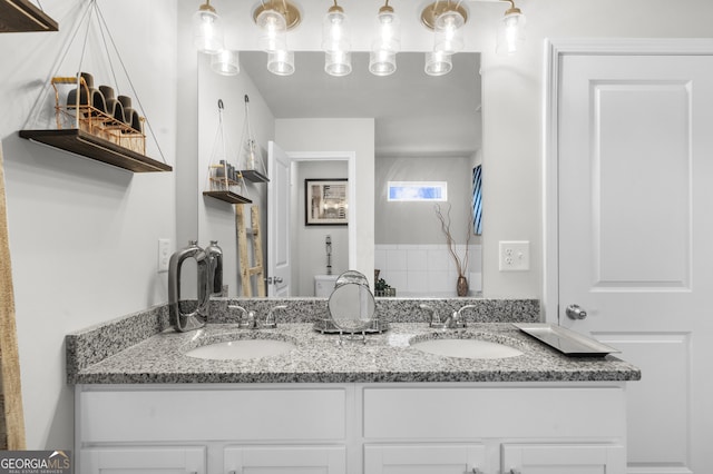 bathroom featuring double vanity and a sink