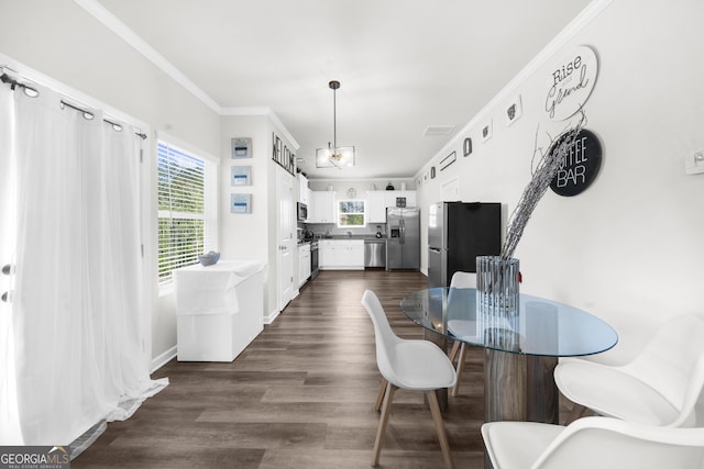 dining room with dark wood-style flooring, visible vents, and ornamental molding