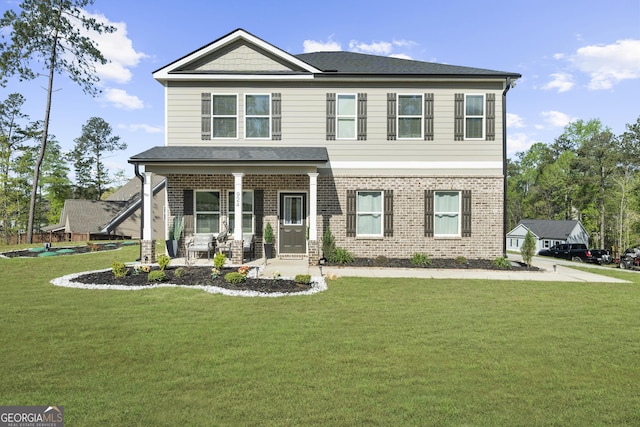 craftsman-style house with a front yard, covered porch, and brick siding