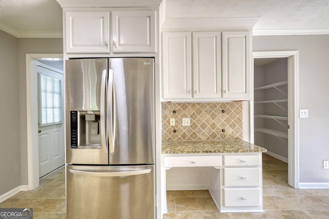 72 Grayson New Hope Rd, Grayson, GA 30017 - kitchen featuring stainless steel fridge with ice dispenser, backsplash, white cabinets, and light stone countertops