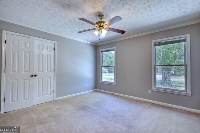 72 Grayson New Hope Rd, Grayson, GA 30017 - unfurnished bedroom featuring a closet, baseboards, a textured ceiling, crown molding, and carpet flooring