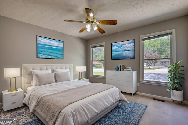 72 Grayson New Hope Rd, Grayson, GA 30017 - bedroom with baseboards, carpet flooring, a textured ceiling, a ceiling fan, and visible vents