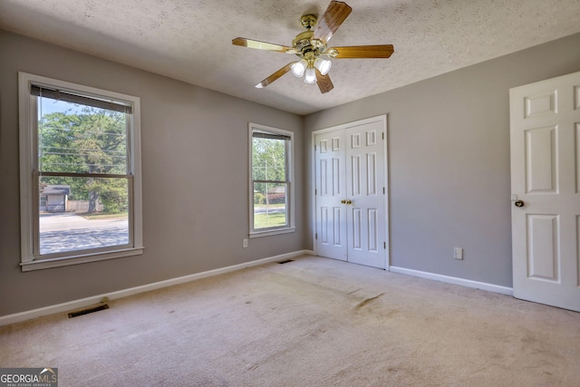72 Grayson New Hope Rd, Grayson, GA 30017 - unfurnished bedroom with light carpet, baseboards, visible vents, and a textured ceiling