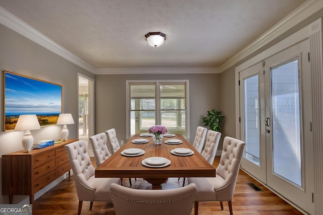 72 Grayson New Hope Rd, Grayson, GA 30017 - dining space featuring crown molding, visible vents, french doors, and a textured ceiling