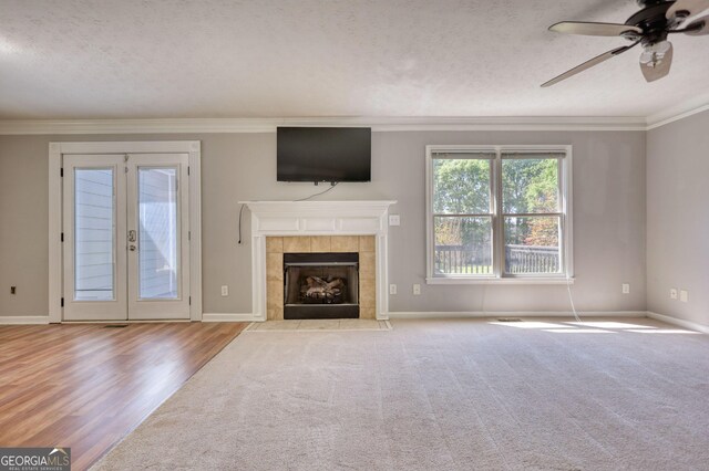 72 Grayson New Hope Rd, Grayson, GA 30017 - unfurnished living room with baseboards, a ceiling fan, a fireplace, crown molding, and a textured ceiling