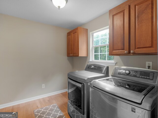 75 The Farm Rd, Mcdonough, GA 30252 - laundry area featuring cabinet space, separate washer and dryer, baseboards, and light wood-type flooring