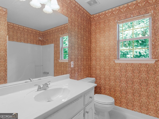 75 The Farm Rd, Mcdonough, GA 30252 - bathroom featuring healthy amount of natural light, vanity, toilet, tile patterned flooring, and wallpapered walls