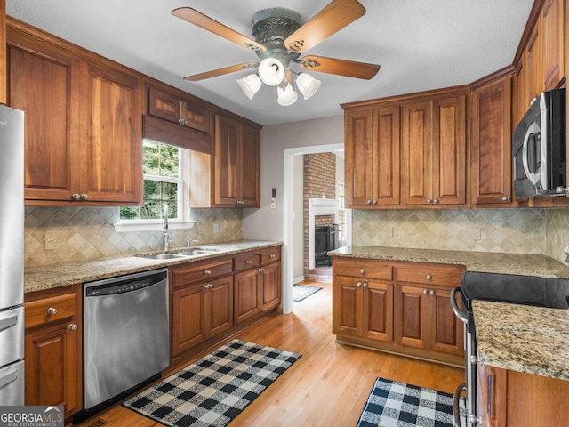 75 The Farm Rd, Mcdonough, GA 30252 - kitchen with appliances with stainless steel finishes, a sink, light wood-style flooring, and tasteful backsplash