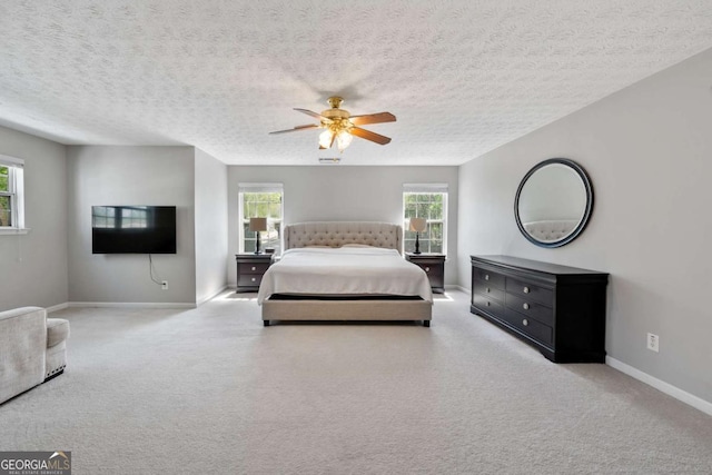 bedroom featuring carpet flooring, baseboards, multiple windows, and ceiling fan