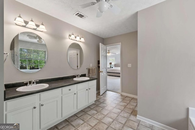 bathroom featuring a sink, visible vents, ceiling fan, and a wealth of natural light