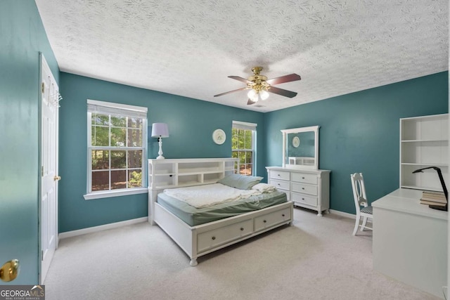 bedroom featuring baseboards, multiple windows, carpet flooring, and ceiling fan