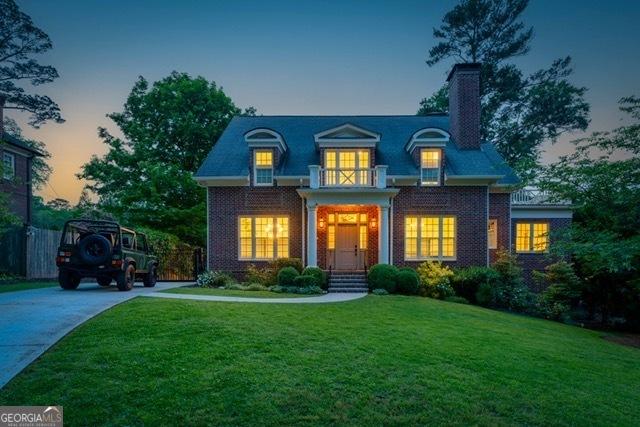 1116 Dan Johnson Rd NE, Atlanta, GA 30307 - view of front facade featuring a chimney, a front yard, and driveway