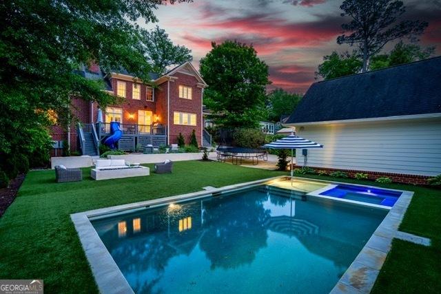 1116 Dan Johnson Rd NE, Atlanta, GA 30307 - view of swimming pool featuring a pool with connected hot tub, a yard, and stairway